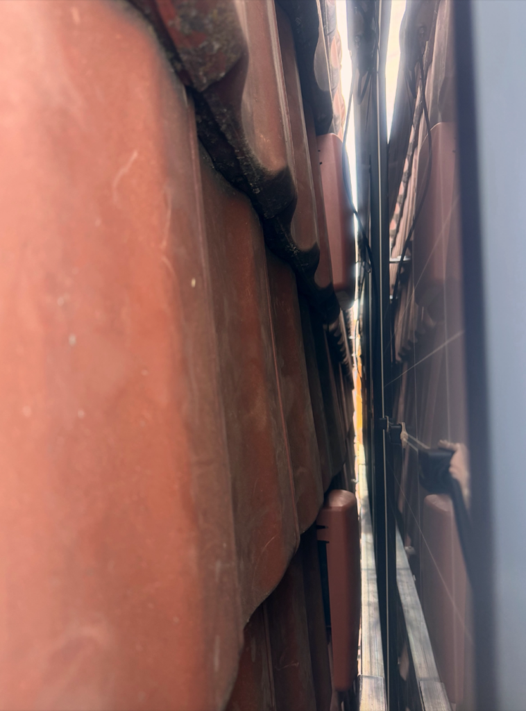 Seitliche Ansicht der montierten Photovoltaikmodule mit Kabelverlegung auf dem Ziegeldach